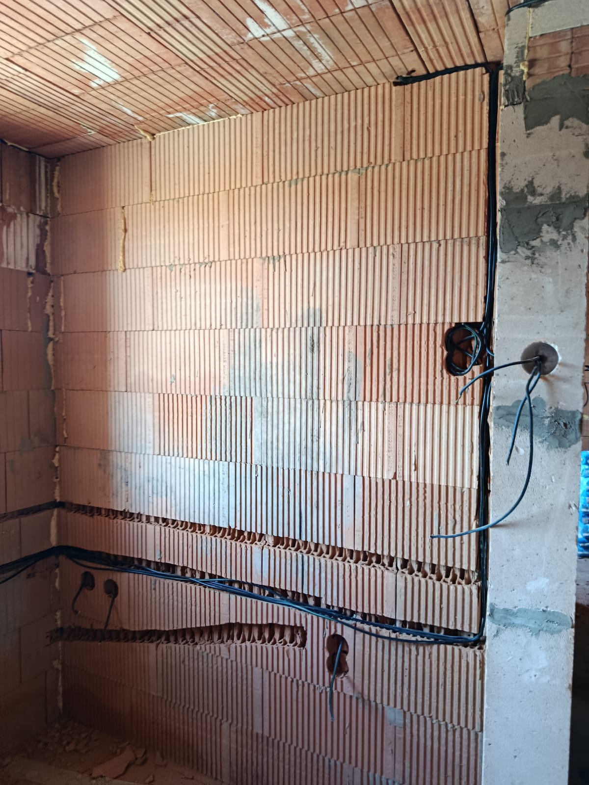 Stěna z cihelných bloků se svislou a vodorovnými drážkami pro elektroinstalaci